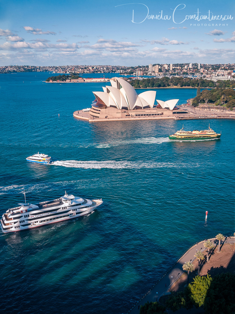 White pearl of Sydney Opera House in the blue waters of Sydney Harbour