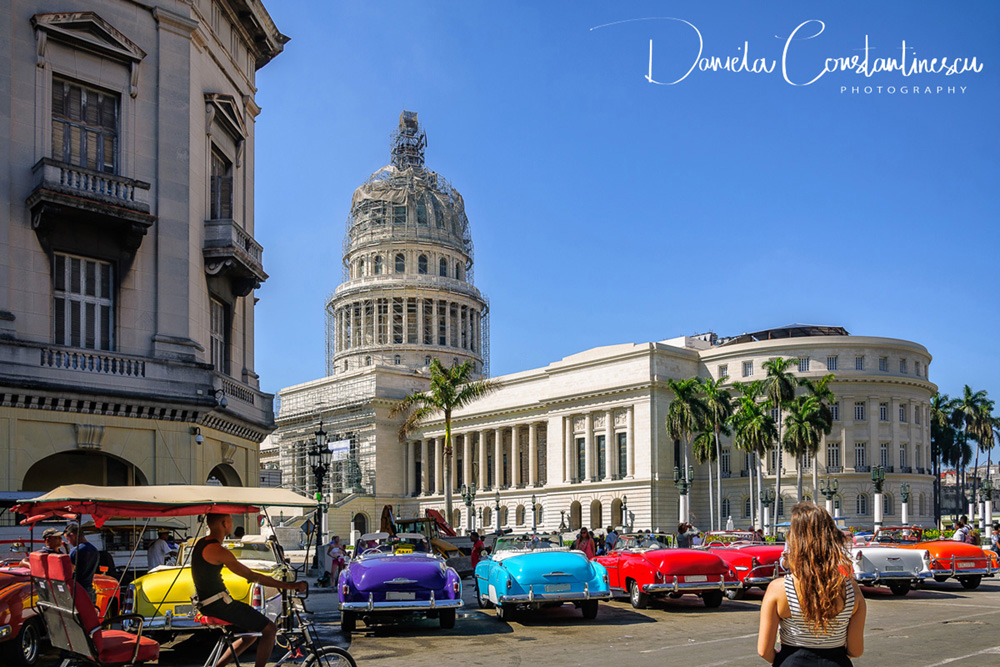 El Capitolio with beautiful vintage taxis in front